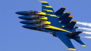 U.S. Navy Blue Angels in formation under clear skies