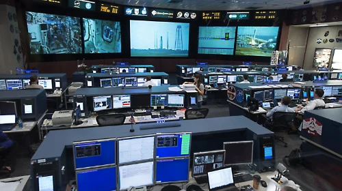 Mission control–style operations center monitoring global flight watch and live traffic